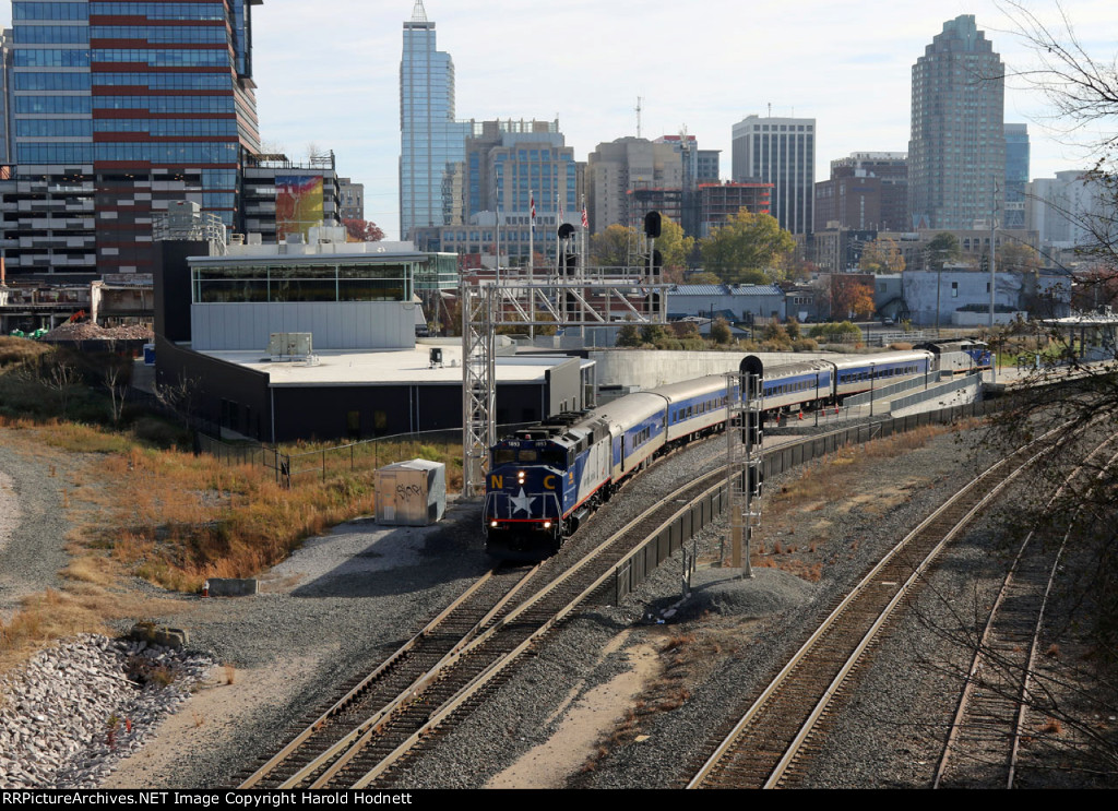 RNCX 1893 leads train P075-24 away from the station